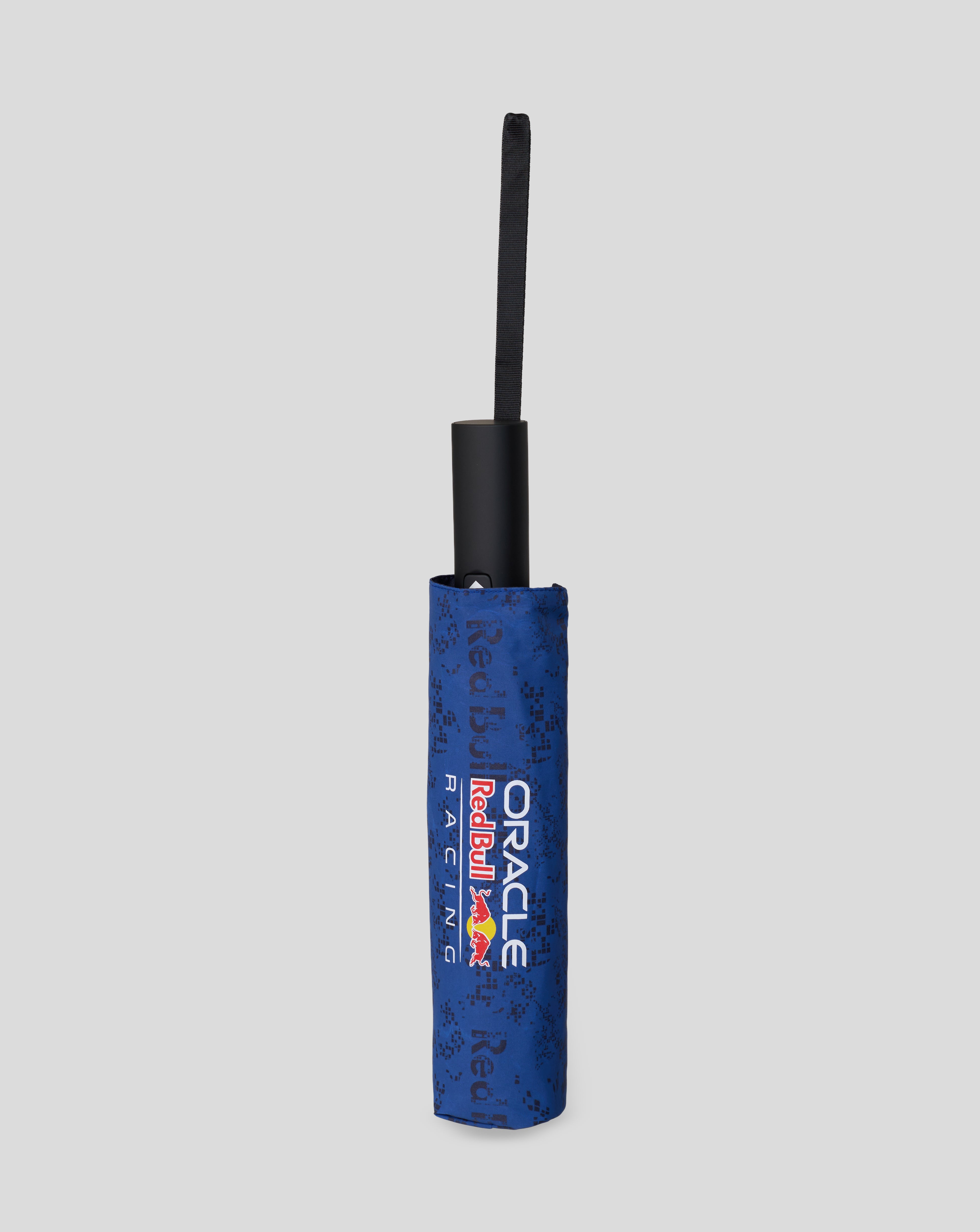 Lower portion of the extended blue umbrella showing Oracle Red Bull Racing branding on the sleeve