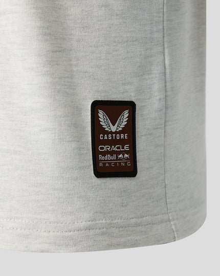 Close up of a brown Castore patch with Oracle Red Bull Racing branding on light gray fabric.