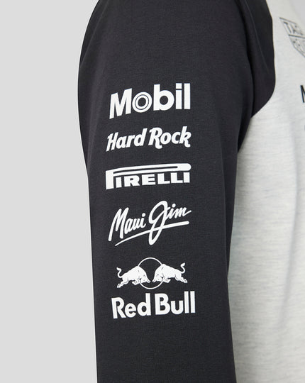 Black sleeve of a Raglan shirt featuring white sponsor logos Mobil Hard Rock Pirelli Maui Jim and Red Bull