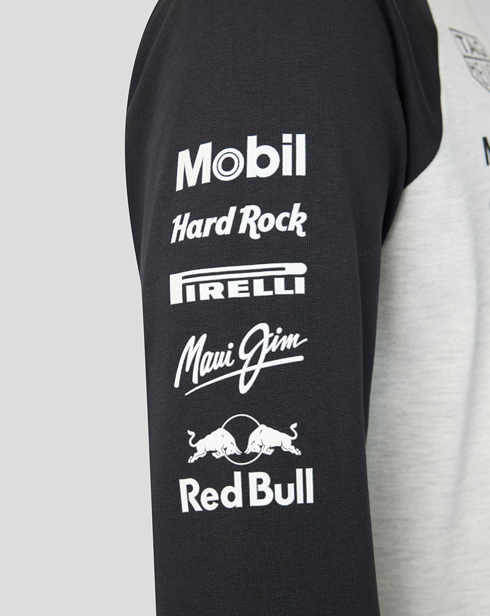 Black sleeve of a Raglan shirt featuring white sponsor logos Mobil Hard Rock Pirelli Maui Jim and Red Bull